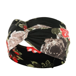 Close-up of floral boho yoga headband with a twist knot design and vintage paisley pattern