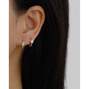 Close-up of S925 sterling silver star and moon earrings with sparkling crystals