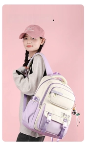 Purple and beige casual college backpack with cartoon bear detail on pink background