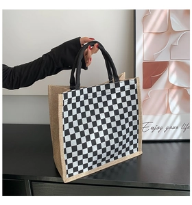 Close-up of black and white checkered linen tote bag with durable woven handles