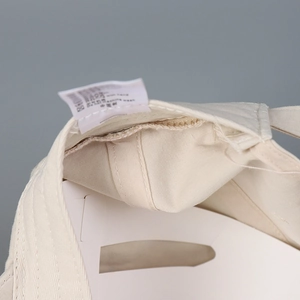 Detail view of cotton baseball cap interior showing precise stitching and care label