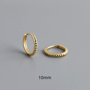 Macro shot of 10mm gold S925 sterling silver huggie earrings with beaded texture detail