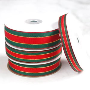 Close-up of festive red and green striped grosgrain ribbons with gold accents for gifting