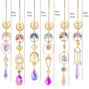 Detail of tree of life crystal suncatchers with metal moon and star hanging prisms