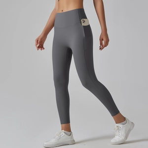 Close-up of grey high-waisted yoga pants featuring a side pocket with a smartphone