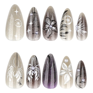 Y2K almond press-on nails with 3D white flowers and black gradient cat eye effect