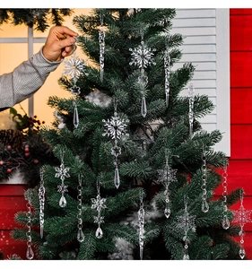 Close-up of clear acrylic snowflake and spiral icicle ornaments on a Christmas tree
