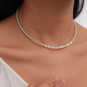 Close-up of a luxury silver necklace with square-cut zircons worn by a model