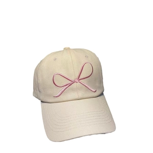 Women beige baseball cap with pink embroidered bow, stylish sun hat for summer look