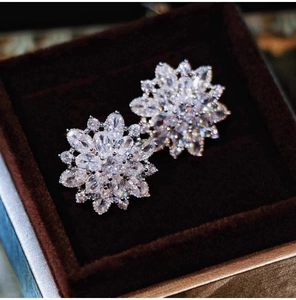 Macro shot of silver flower earrings with marquise and round cut cubic zirconia stones