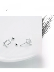 Detail showing S925 sterling silver stamp and screw back on minimalist heart earrings