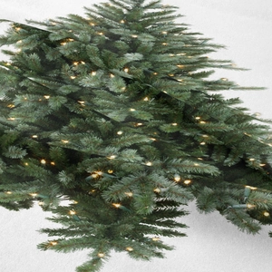 Dettaglio del tessuto stampato albero di Natale con luci LED e trama a rete fine