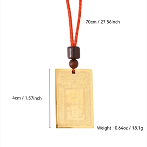 Macro detail of golden 18k gold plated Kaiyun pendant with red woven cord and wood beads