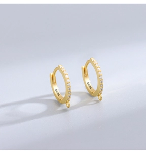 Detail of S925 sterling silver hoop earrings with small zircon inlay and gold plating