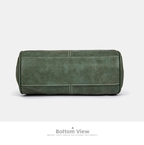 Detailed view of dark green retro bag bottom with white contrast stitching and fine leather texture