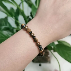 Soulmate Morse code bracelet with natural tiger eye beads and hematite spacers on wrist