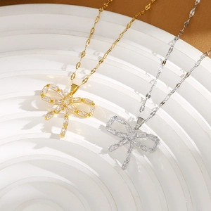 Elegant bow pendant necklace in gold and silver finish with sparkling zircon inlay