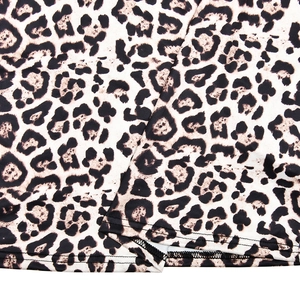 Close-up of leopard print fabric texture and high-quality black stitching details