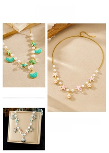 Detail of beaded shell starfish necklaces with pearls and colorful beach pendants