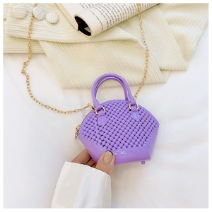 Detailed view of mini purple jelly shell bag featuring woven texture and gold chain strap