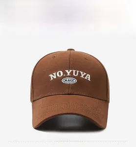 Close-up of brown baseball cap featuring white NO.YUYA and blue IMAGE embroidery