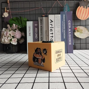 Electric gorilla themed coin bank with cartoon design on a stylish modern desk setup