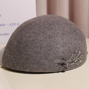 Detail view of a luxury wool beret with a sparkly crystal wheat ear embellishment