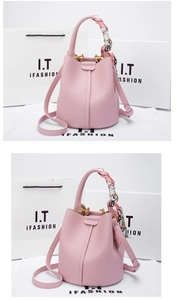 Detail of pink lychee leather bucket bag with silk scarf handle and gold hardware