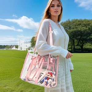 Outdoor shot of a clear PVC beach tote bag with pink straps shown on shoulder