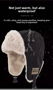 Waterproof testing on black winter trapper hat with warm plush lining and ear flaps