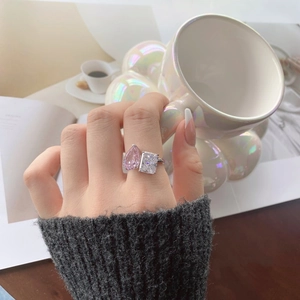 Detailed macro view of S925 silver ring featuring pink pear and white emerald cut stones