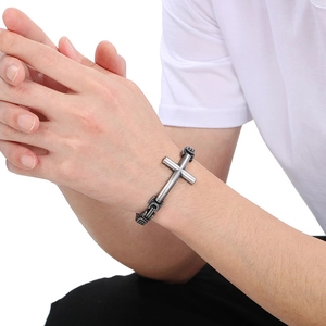 Detailed view of vintage men's stainless steel Byzantine chain with cross plate on wrist