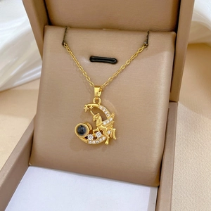 Macro detail of gold Pegasus and moon pendant with crystals and projection bead