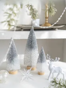 Three mini flocked Christmas trees with wooden bases and white reindeer decor set