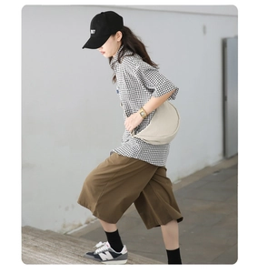 Nylon half-moon crossbody bag shown in a casual outdoor minimalist styling look