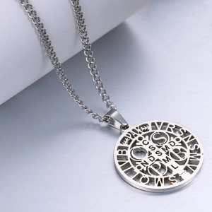 Detailed view of Saint Benedict medal pendant with hollow cross and engraved letters