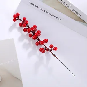 Detailed view of glossy red artificial berries branch for festive home decoration