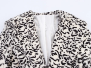 Detailed close-up of faux fur collar with black and white leopard print and white lining