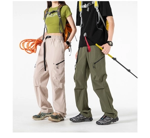 Detail of cargo pants showing zipper pockets, built-in belts and knee articulation