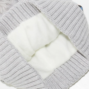 Detail of warm grey knit hat showing thick white fleece lining for winter insulation