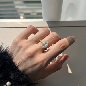 Macro detail of the oval yellow gemstone with micro-pave diamonds on the golden ring