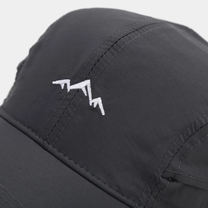 Detailed close-up of mountain peak embroidery on a grey quick-dry outdoor baseball cap