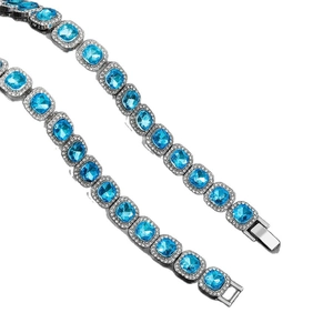 Silver hip hop necklace with square blue gemstones and white pavé zircon stones on white backdrop