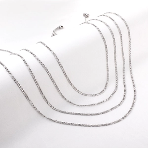 Detailed view of silver stainless steel Figaro chains with lobster clasps in various lengths