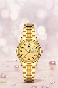 Detailed view of women's gold quartz watch with calendar display and steel band