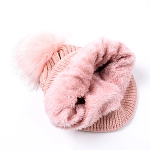 Detail of pink knitted beanie and neck gaiter set with warm thick fleece lining
