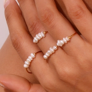 Minimalist 18K gold-plated stainless steel ring with delicate freshwater pearls on finger