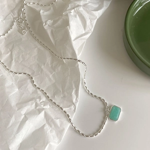 Macro shot of s925 silver necklace featuring a rectangular green amazonite stone pendant