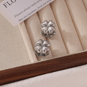 Elegant silver four-leaf clover stud earrings in a premium jewelry presentation box