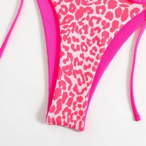 Macro shot of pink leopard print bikini bottom with side ties and high-stretch fabric